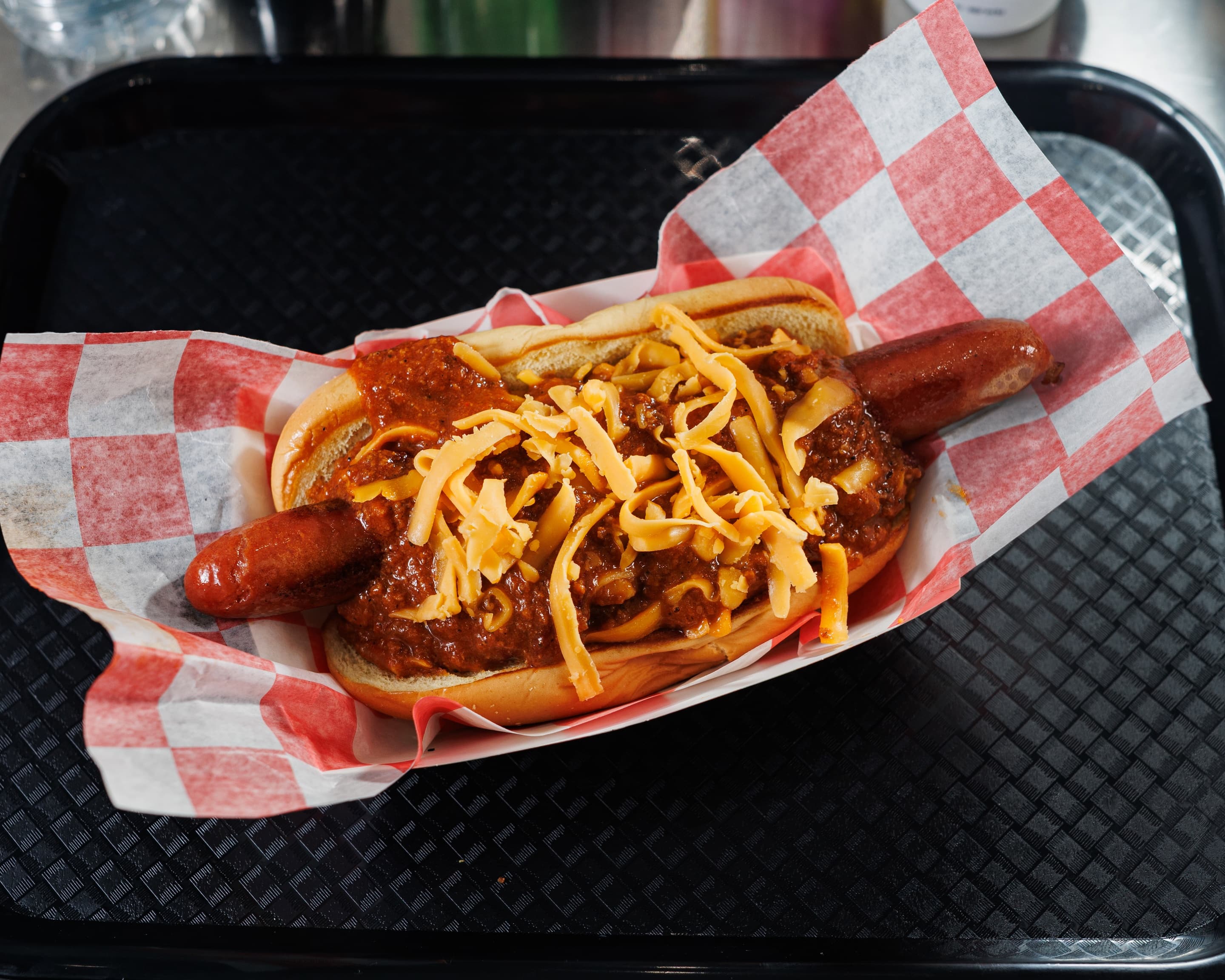 Chili cheese dog loaded with beefy chili and shredded cheddar on a toasted bun